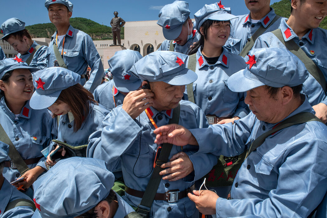 游客在延安革命纪念馆毛泽东雕像旁准备合影
