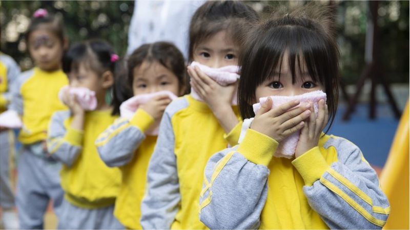 Kindergarten children take part in a fire evacuation drill on the first day of a new semester